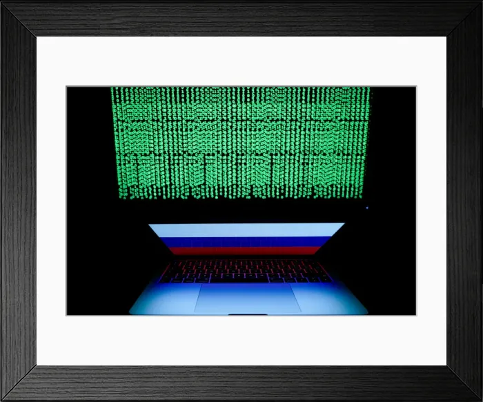 Framed Print : Russian flag is seen on the laptop screen in front of a computer screen on which cyber Framed Print : Russian flag is seen on the laptop screen in front of a computer screen on which cyber