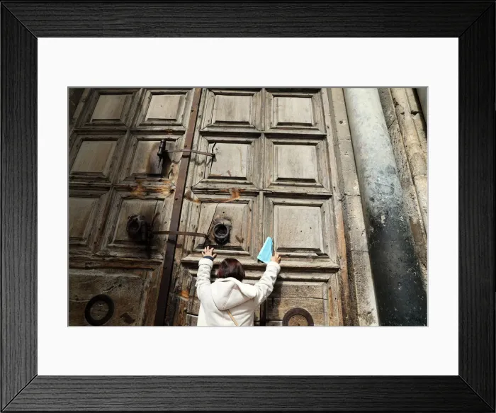 Framed Print : A worshipper touches the closed doors of the Church of the Holy Sepulchre in Jerusalem s Framed Print : A worshipper touches the closed doors of the Church of the Holy Sepulchre in Jerusalem s