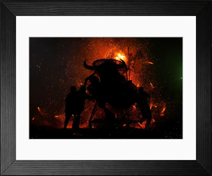 Framed Print : People enjoy fireworks exploding from a traditional bull figure known as El Torito in Framed Print : People enjoy fireworks exploding from a traditional bull figure known as El Torito in