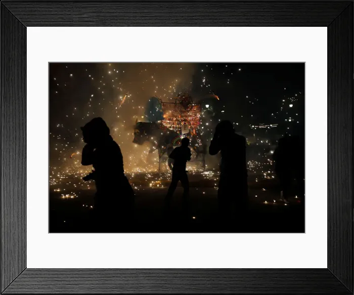 Framed Print : People enjoy fireworks exploding from a traditional bull figure known as El Torito in Framed Print : People enjoy fireworks exploding from a traditional bull figure known as El Torito in