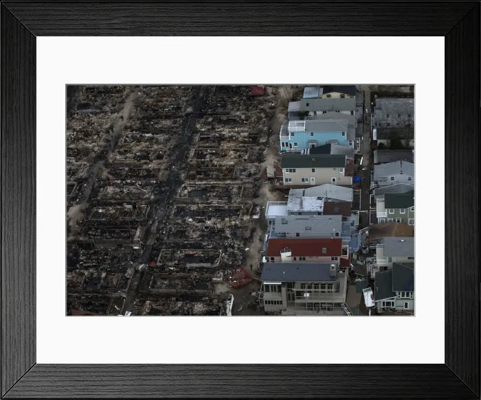 Framed Print : Burned houses are seen next to those which survived in Breezy Point after they were Framed Print : Burned houses are seen next to those which survived in Breezy Point after they were