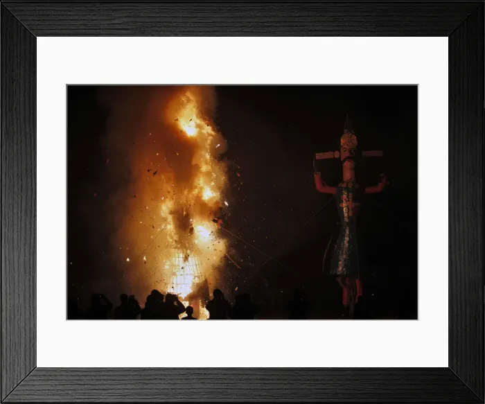 Framed Print : Photographers take pictures of an effigy of Meghnad after it is set on fire during