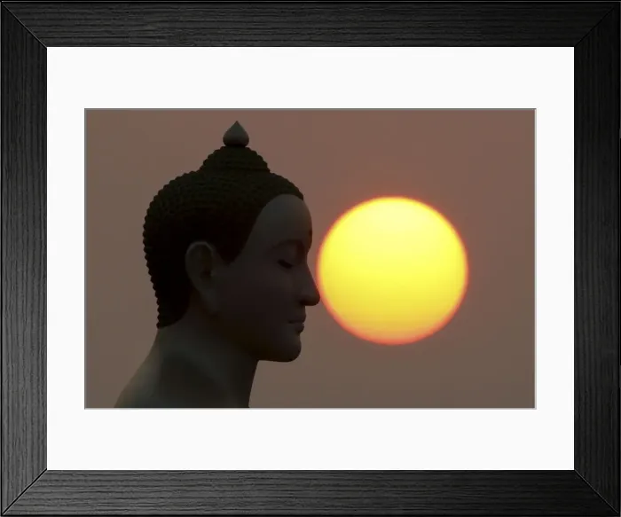 Framed Print : The sun rises next to a Buddha statue while monks and novices gather to receive alms Framed Print : The sun rises next to a Buddha statue while monks and novices gather to receive alms