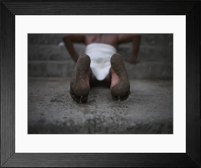 Framed Print : A Hindu devotees feet are seen while he rolls on the ground during the first day of