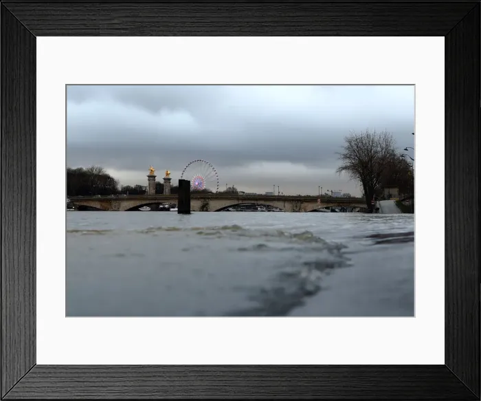 Framed Print : A view shows the Pont Alexandre III bridge and flooded banks of the Seine River after