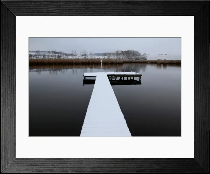 Framed Print : Snow covered pier is seen on a lake near the village of Etyek Framed Print : Snow covered pier is seen on a lake near the village of Etyek