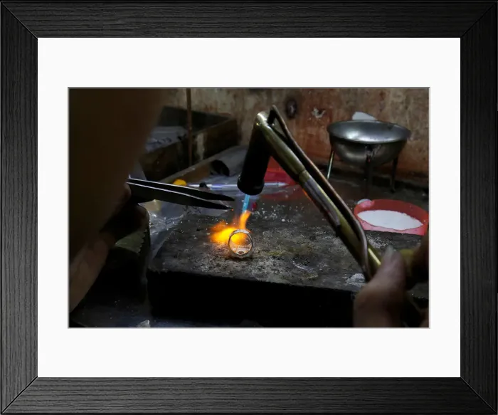 Framed Print : A man works on a silver ring at a workshop in Hanoi Framed Print : A man works on a silver ring at a workshop in Hanoi