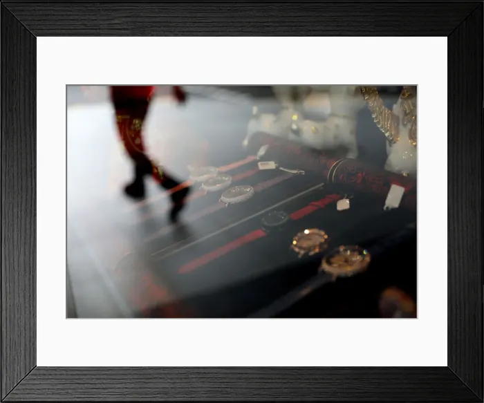 Framed Print : The reflection of a man walking is seen in the window of a shop selling watches in Framed Print : The reflection of a man walking is seen in the window of a shop selling watches in