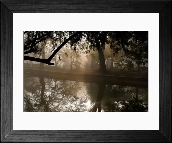 Framed Print : People walk by a lake at a public park on a foggy winter morning in New Delhi Framed Print : People walk by a lake at a public park on a foggy winter morning in New Delhi