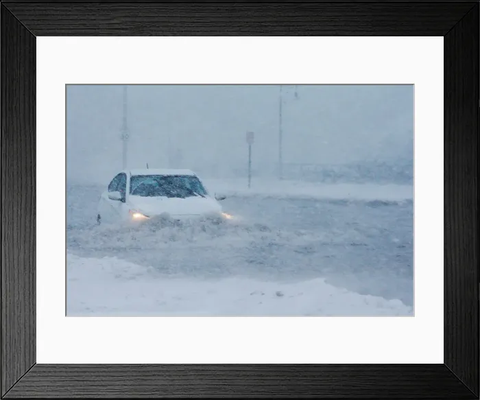 Framed Print : Drivers make their way along the flooded Beach Road after the ocean overtopped