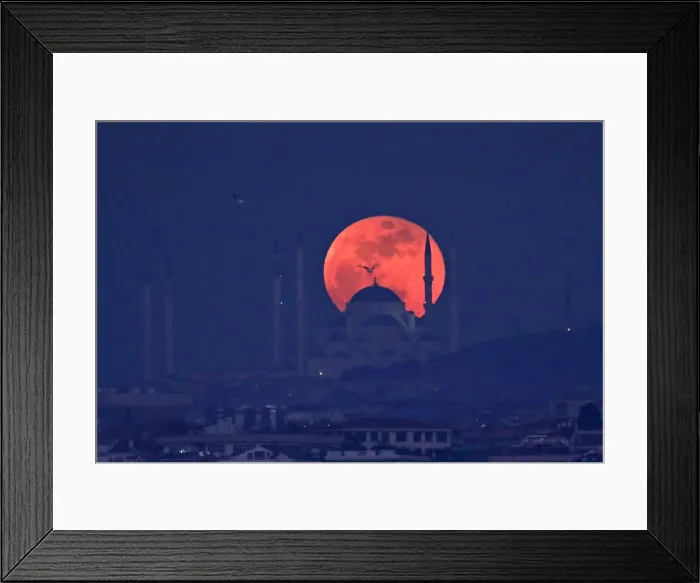 Framed Print : A full moon rises behind a mosque over the Camlica hill in Istanbul