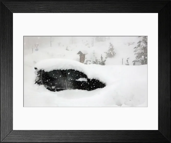Framed Print : A car is seen during heavy snowfall in Claviere