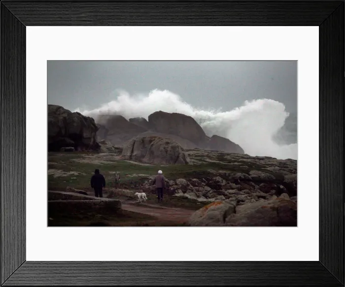 Framed Print : People watch waves breaking on the Brittany coast after storm Eleanor hit Saint-Guenole