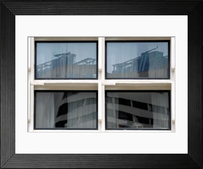 Framed Print : Reflection of construction sites is seen on glass panels of a building in Colombo Framed Print : Reflection of construction sites is seen on glass panels of a building in Colombo