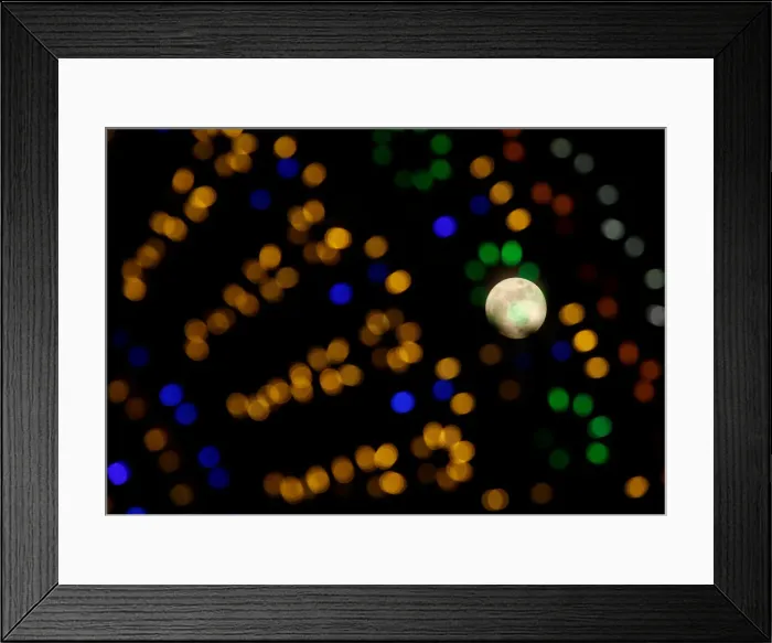 Framed Print : The supermoon full moon is seen through Christmas lights in Valletta