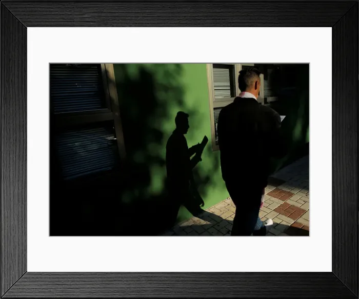 Framed Print : A man checks his documents after leaving a government-run job centre in Malaga Framed Print : A man checks his documents after leaving a government-run job centre in Malaga