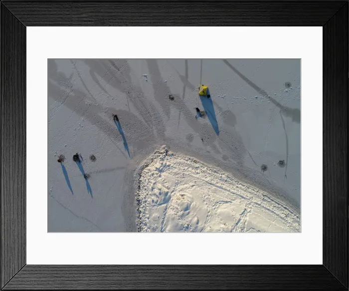 Framed Print : An aerial view shows men fishing on thin ice covering the Yenisei River outside