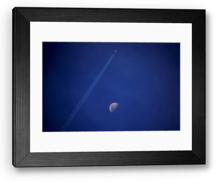 Framed Print : A plane leaves a vapor trail as it flies past the moon above the town of Gunnedah Framed Print : A plane leaves a vapor trail as it flies past the moon above the town of Gunnedah