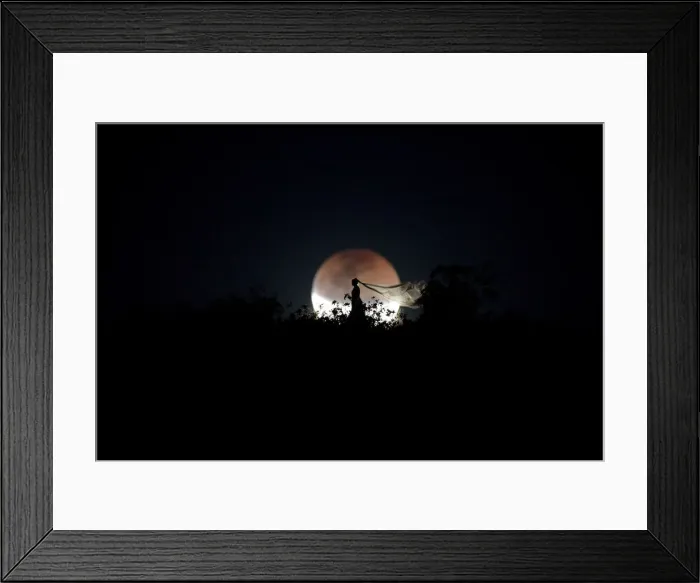 Framed Print : A bride poses for photo during a total lunar eclipse from in Brasilia Framed Print : A bride poses for photo during a total lunar eclipse from in Brasilia