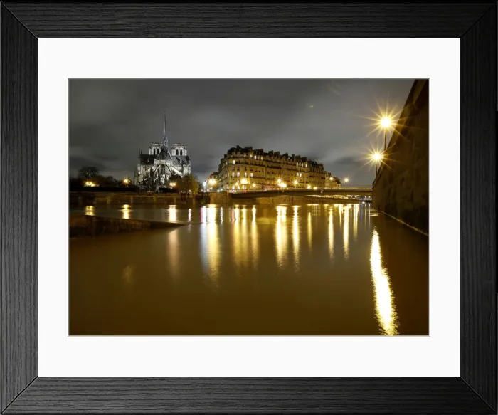 Framed Print : A general view shows the Notre Dame Cathedral at night, on the flooded banks of the River Framed Print : A general view shows the Notre Dame Cathedral at night, on the flooded banks of the River