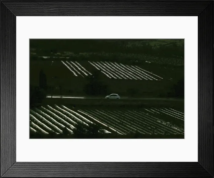 Framed Print : A car passes along a road in between crop-growing fields outside Burmarrad Framed Print : A car passes along a road in between crop-growing fields outside Burmarrad