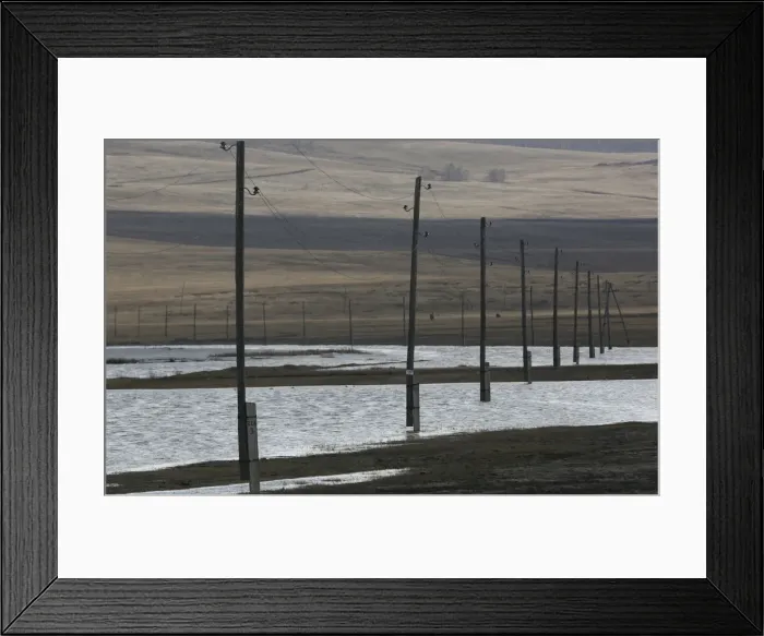 Framed Print : Electricity pylons are seen on the flooded banks of a lake in the Siberian village of Framed Print : Electricity pylons are seen on the flooded banks of a lake in the Siberian village of
