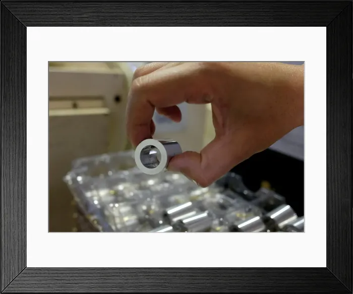 Framed Print : Components made from aluminium are seen inside a factory in Dongguan