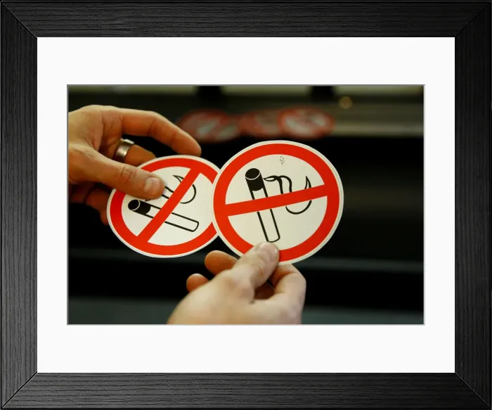 Framed Print : An employee shows no smoking signs in the Karas printing shop in Vienna Framed Print : An employee shows no smoking signs in the Karas printing shop in Vienna