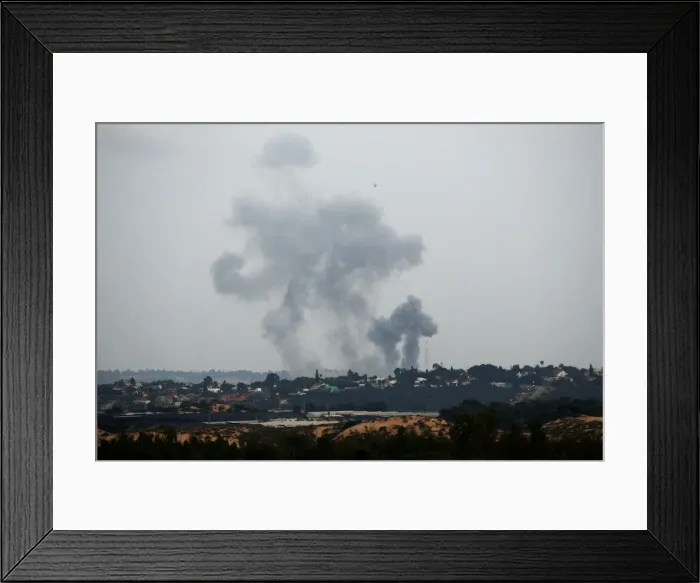 Framed Print : Smoke rises following an Israeli air strike on the Gaza Strip as seen from the Israeli Framed Print : Smoke rises following an Israeli air strike on the Gaza Strip as seen from the Israeli