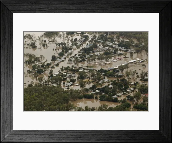 Framed Print : An aerial view of partially submerged houses in flooded Theodore in Australias state of