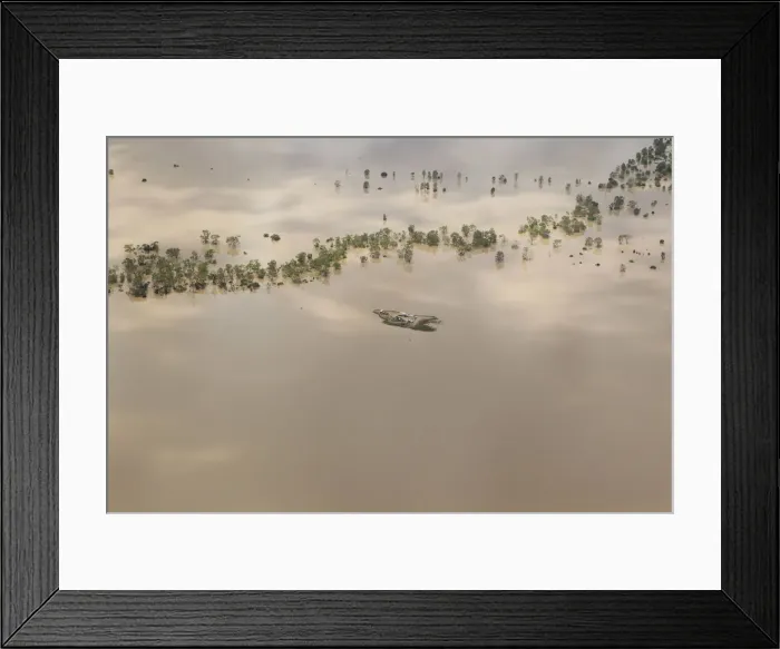 Framed Print : Agricultural machinery is seen on an isolated island surrounded by flood waters near Framed Print : Agricultural machinery is seen on an isolated island surrounded by flood waters near