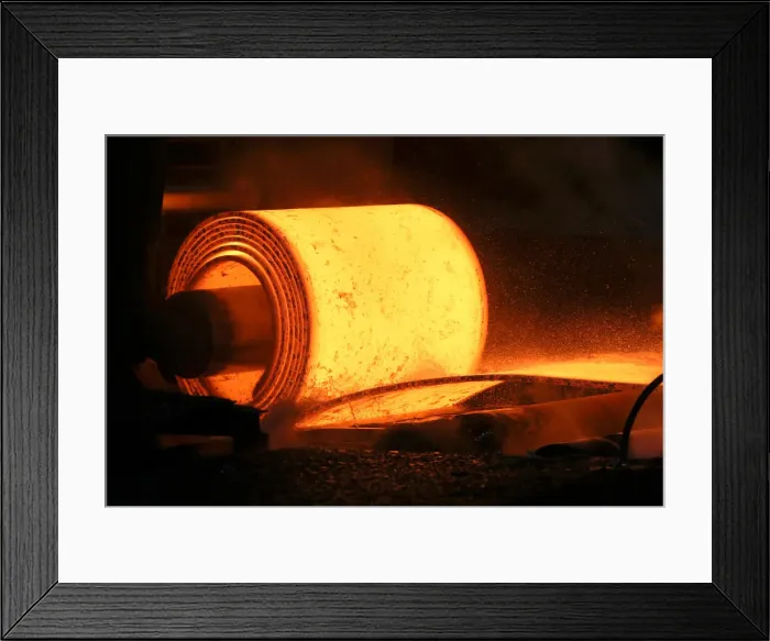Framed Print : A steel coil is unrolled on the line at the Novolipetsk Steel PAO steel mill in Farrell