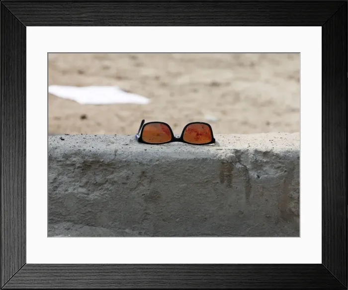 Framed Print : A pair of sunglass with blood is seen at the site of a suicide bomb attack near a Shi ite Framed Print : A pair of sunglass with blood is seen at the site of a suicide bomb attack near a Shi ite