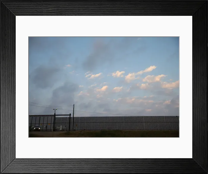 Framed Print : A U. S. Border Patrol agent guards a section of border fence by the Mexico-U. S Framed Print : A U. S. Border Patrol agent guards a section of border fence by the Mexico-U. S