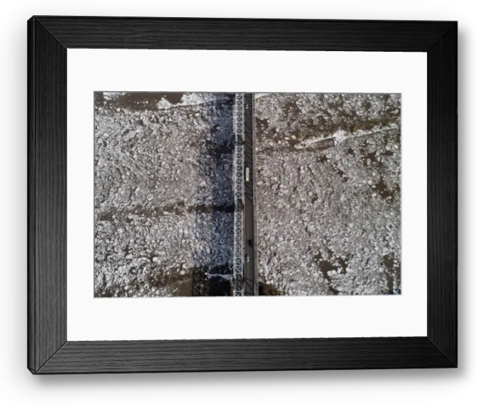 Framed Print : A view shows vehicles driving along a bridge across the Mana River during an ice drift Framed Print : A view shows vehicles driving along a bridge across the Mana River during an ice drift