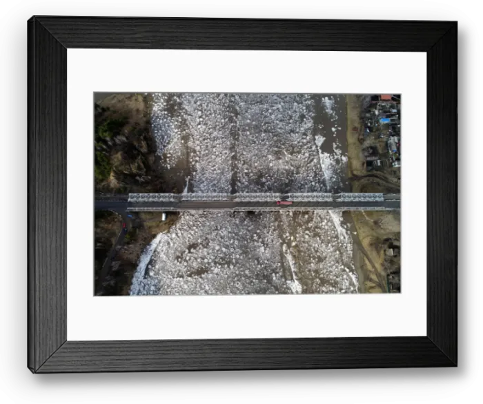 Framed Print : A view shows vehicles driving along a bridge across the Mana River during an ice drift Framed Print : A view shows vehicles driving along a bridge across the Mana River during an ice drift