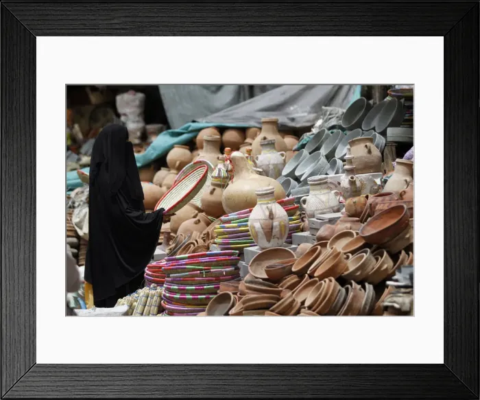 Framed Print : A woman shops at the old market in the historic city of Sanaa Framed Print : A woman shops at the old market in the historic city of Sanaa