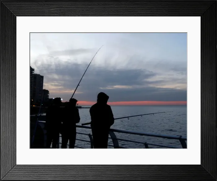 Framed Print : People are seen fishing ar the seaside during sunset in Beirut Framed Print : People are seen fishing ar the seaside during sunset in Beirut