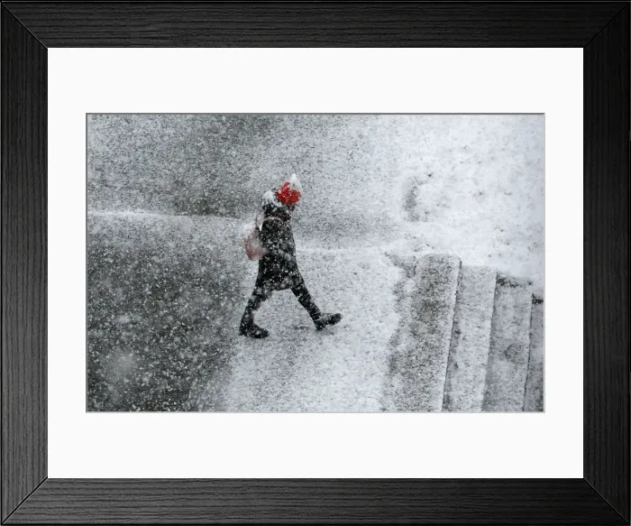 Framed Print : A pedestrian walks during a heavy snowfall in the Siberian town of Divnogorsk Framed Print : A pedestrian walks during a heavy snowfall in the Siberian town of Divnogorsk
