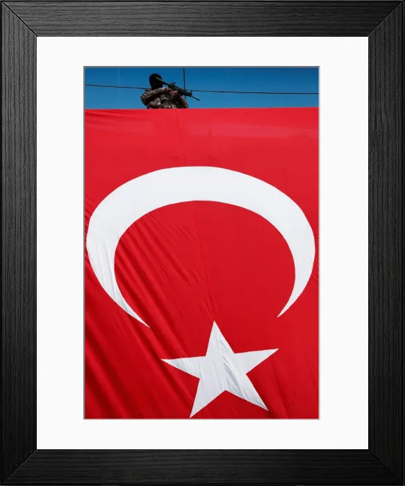 Framed Print : A member of police special forces stands guard during a protest against the removal of Framed Print : A member of police special forces stands guard during a protest against the removal of