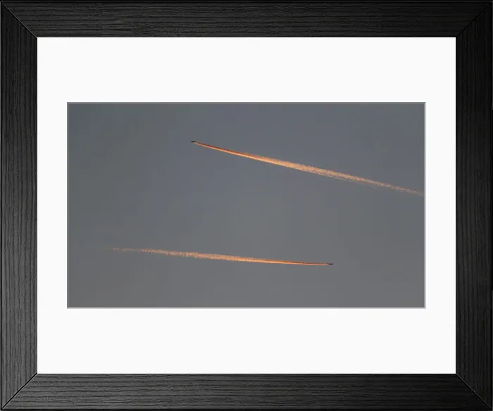 Framed Print : Passenger planes leave behind contrails as they fly in the skies over London Luton Framed Print : Passenger planes leave behind contrails as they fly in the skies over London Luton
