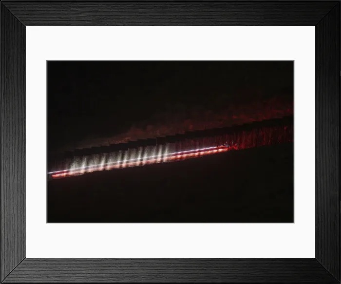 Framed Print : U. S. border patrol vehicle is seen from the Mexican side of the border while driving near