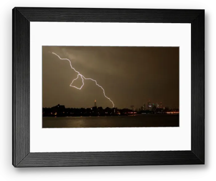 Framed Print : General view as lightning strikes over the city of London, Britain Framed Print : General view as lightning strikes over the city of London, Britain