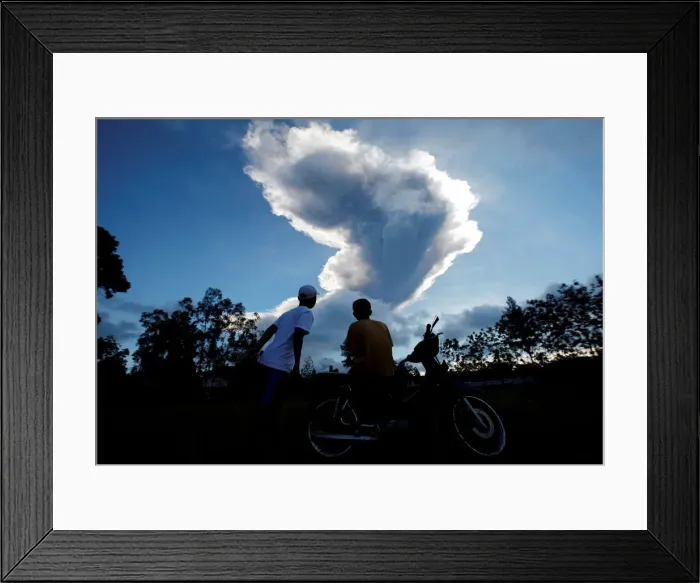 Framed Print : People watch as Mount Merapi volcano erupts from Purwobinangun Village, near Yogyakarta