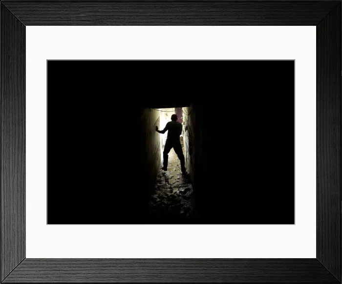 Framed Print : A man walks on mud inside his house after a flood in the low-income neighborhood of Framed Print : A man walks on mud inside his house after a flood in the low-income neighborhood of