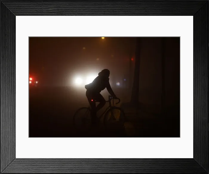 Framed Print : A person cycles through heavy fog in Dublin Framed Print : A person cycles through heavy fog in Dublin