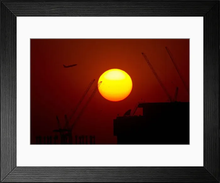 Framed Print : A passenger jet flies past the setting sun in Shanghai Framed Print : A passenger jet flies past the setting sun in Shanghai
