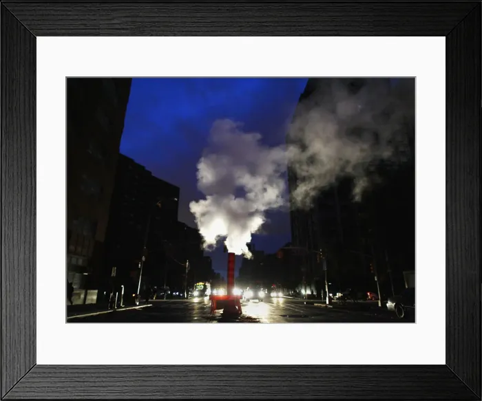Framed Print : Steam rises from out of a vent in the middle of a blackout in the aftermath of Hurricane