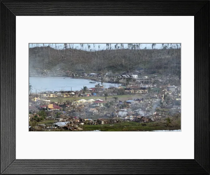 Framed Print : A view of the devastation caused at the height of Typhoon Bopha in the coastal town of Framed Print : A view of the devastation caused at the height of Typhoon Bopha in the coastal town of