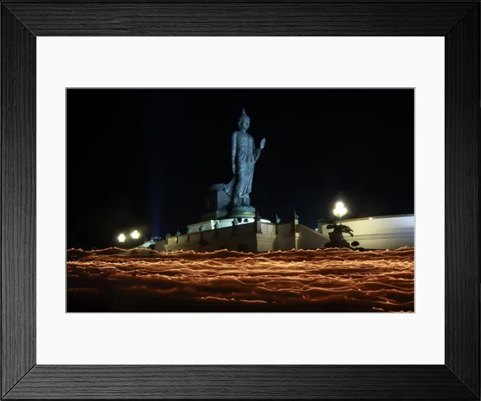 Framed Print : Buddhists carry candles while encircling a large Buddha statue during Vesak Day in Nakhon